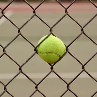 Tennis ball in fence