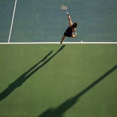 Playing tennis on court
