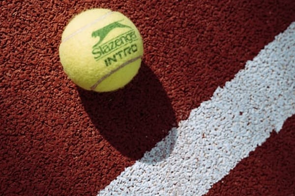 Tennis ball on clay court