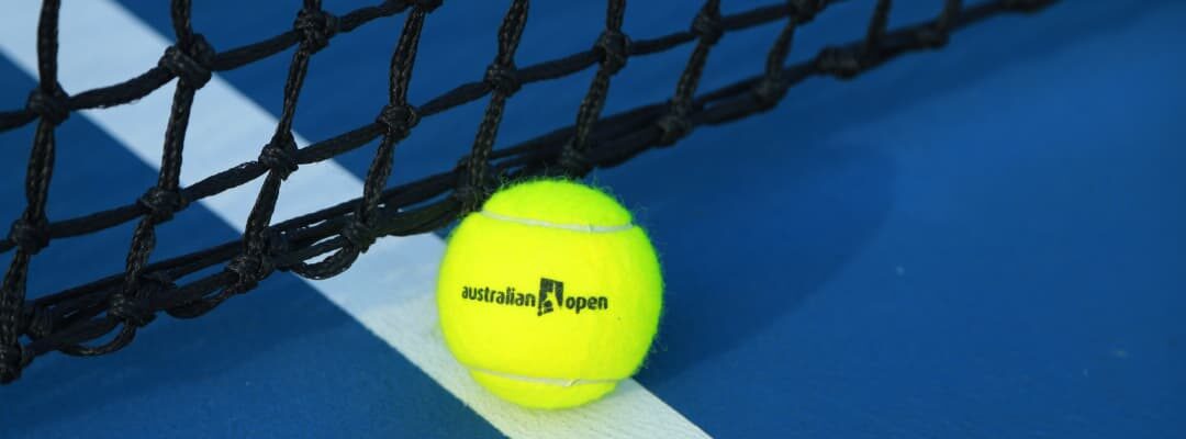 tennis ball on blue court